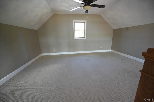 additional living space with light carpet, ceiling fan, and vaulted ceiling