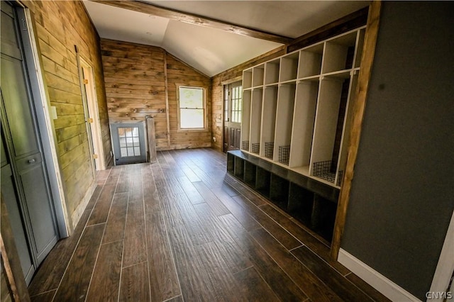 mudroom featuring lofted ceiling with beams, wood walls, and dark wood-type flooring