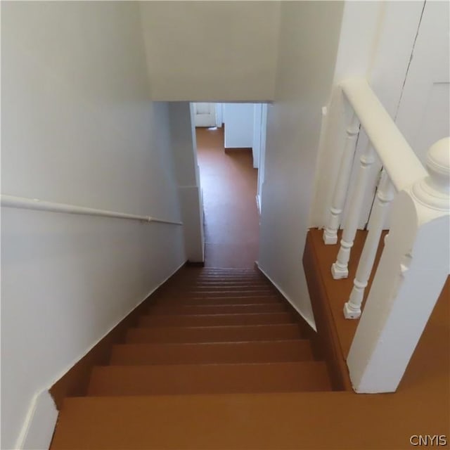 stairs featuring hardwood / wood-style floors