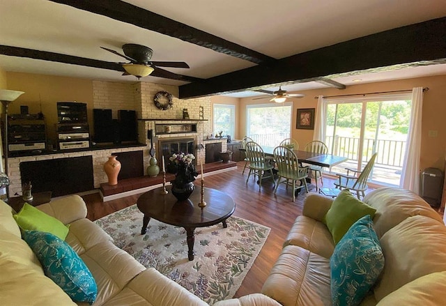 living room with a fireplace, beam ceiling, hardwood / wood-style flooring, and ceiling fan