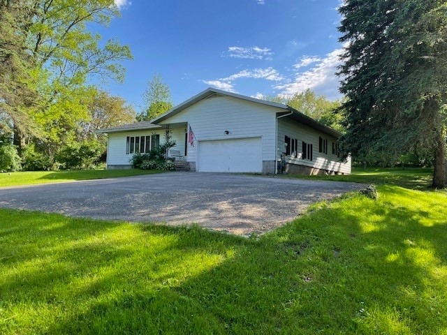 view of property exterior with a garage and a lawn