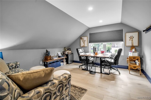 interior space with vaulted ceiling and light hardwood / wood-style flooring