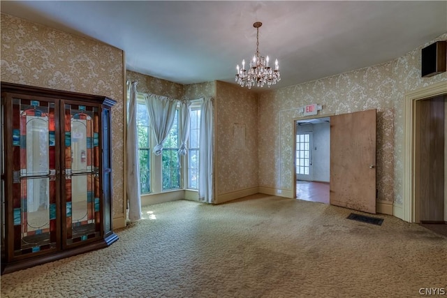 interior space featuring wallpapered walls, an inviting chandelier, baseboards, and carpet floors