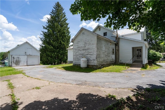 view of property exterior with an outbuilding and a garage