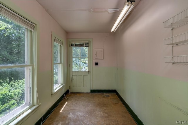 doorway to outside featuring baseboards
