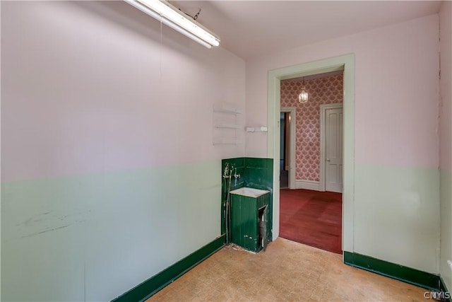 spare room with baseboards