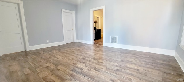 spare room with wood-type flooring