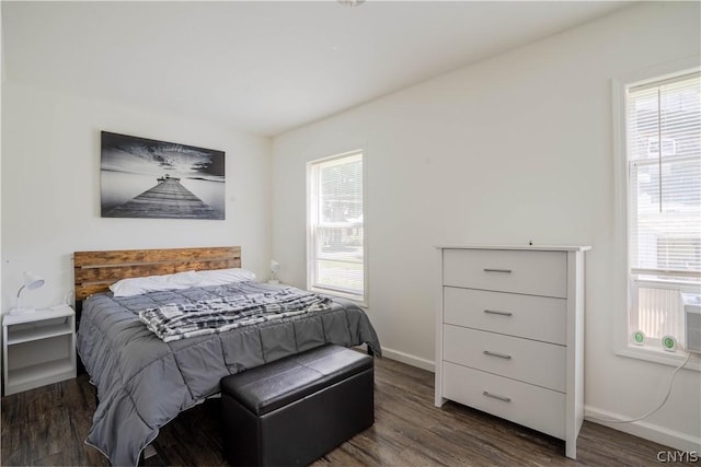 bedroom with dark hardwood / wood-style floors