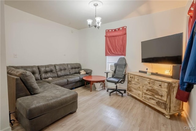 living room featuring a chandelier and light hardwood / wood-style floors