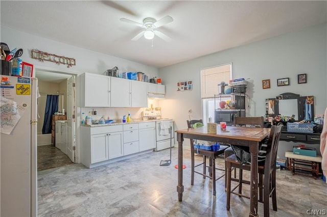 kitchen featuring extractor fan, ceiling fan, white electric stove, white cabinets, and fridge