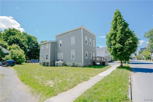 view of side of home with a lawn