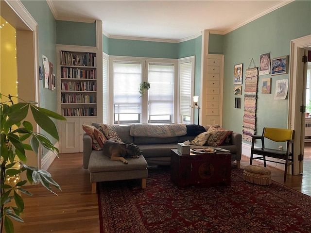 living room with ornamental molding, radiator heating unit, and wood finished floors