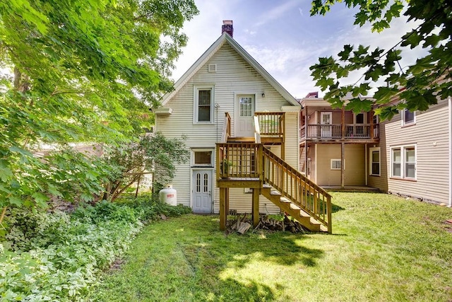 back of property featuring a yard