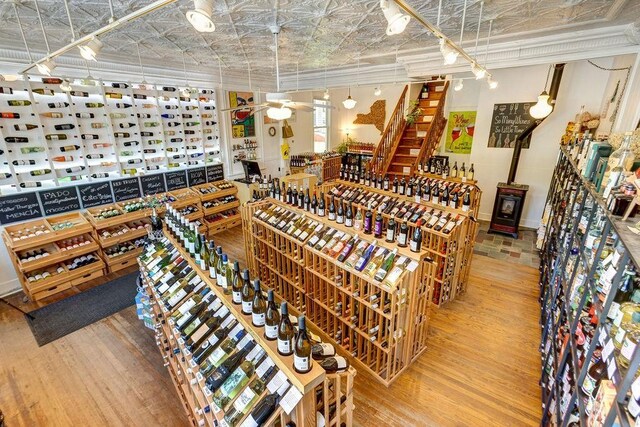 wine area featuring hardwood / wood-style flooring and ceiling fan