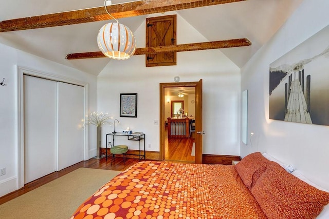 bedroom featuring hardwood / wood-style flooring, high vaulted ceiling, and a closet