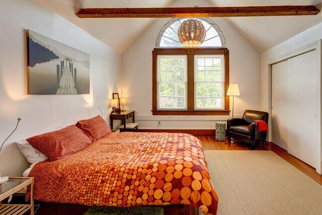 bedroom with lofted ceiling and hardwood / wood-style floors