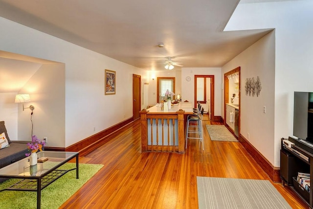 living room featuring hardwood / wood-style flooring and ceiling fan