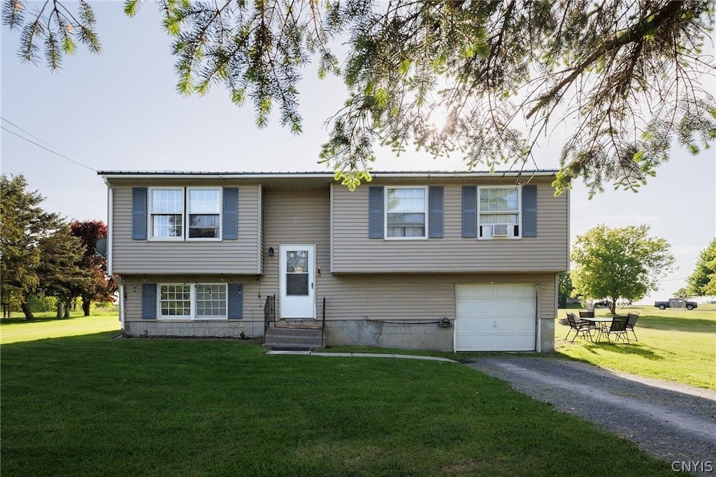 bi-level home with a front yard and a garage