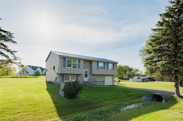 split foyer home featuring a front yard and a garage