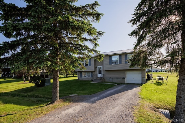 raised ranch with a front yard and a garage