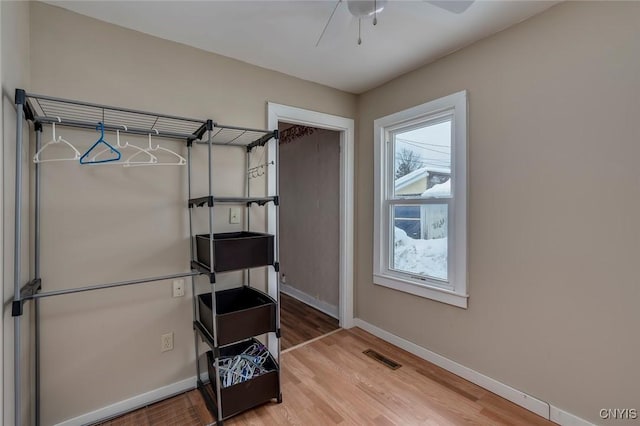 misc room with wood-type flooring and ceiling fan