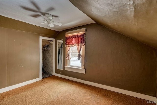 bonus room featuring vaulted ceiling and carpet flooring