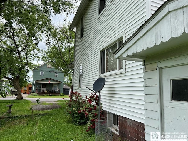 view of side of property with a yard