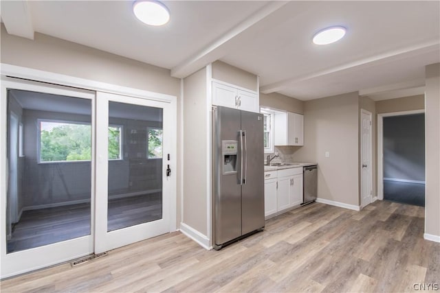 kitchen with white cabinets, stainless steel appliances, light hardwood / wood-style floors, and sink