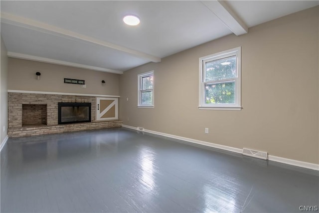 unfurnished living room featuring a fireplace and beam ceiling