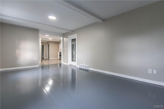 unfurnished room featuring beamed ceiling and wood-type flooring