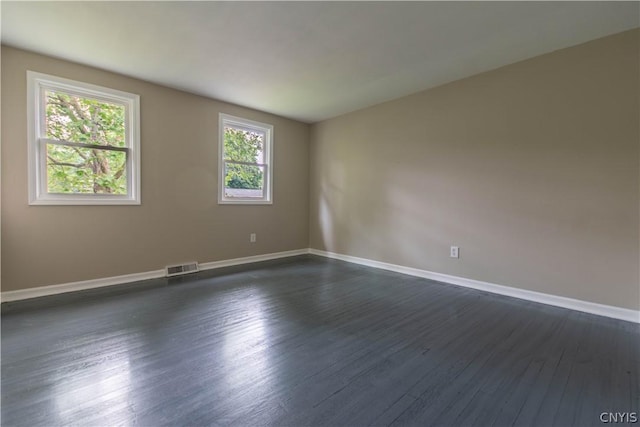 empty room with dark wood-type flooring