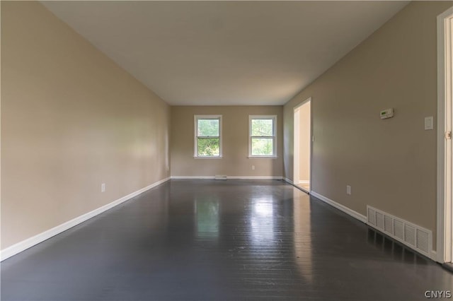 spare room featuring dark hardwood / wood-style floors