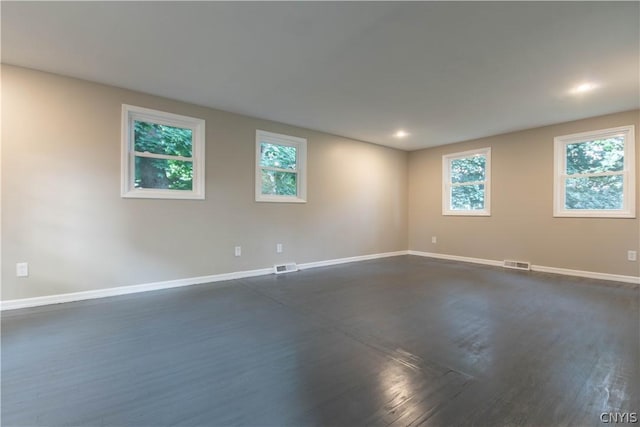 unfurnished room with dark wood-type flooring