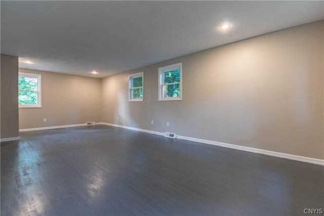 spare room with dark wood-type flooring