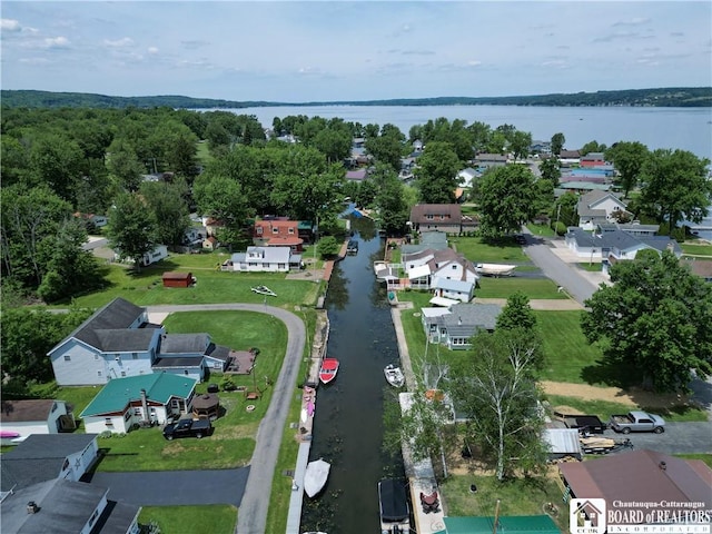 birds eye view of property with a water view