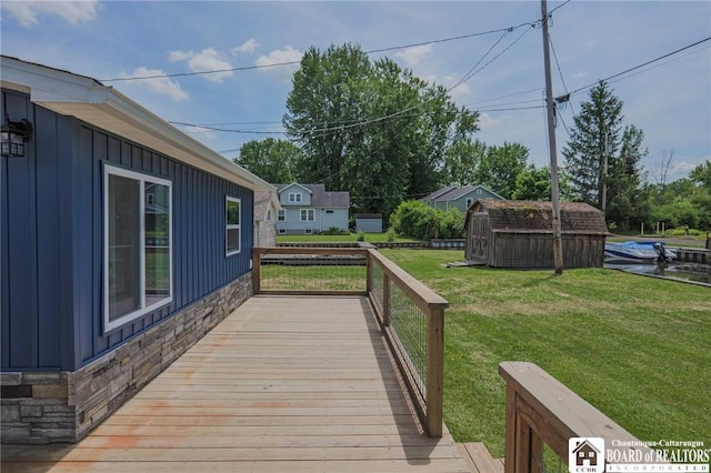 deck with a yard and a storage shed