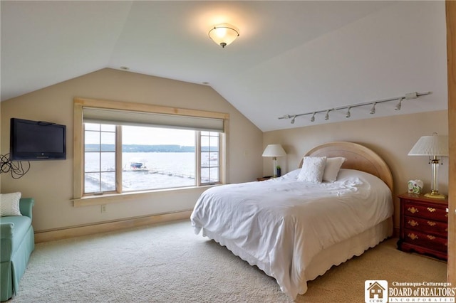 carpeted bedroom with a water view and lofted ceiling