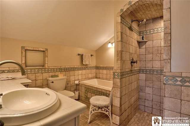 bathroom featuring tile patterned floors, vaulted ceiling, separate shower and tub, toilet, and tile walls