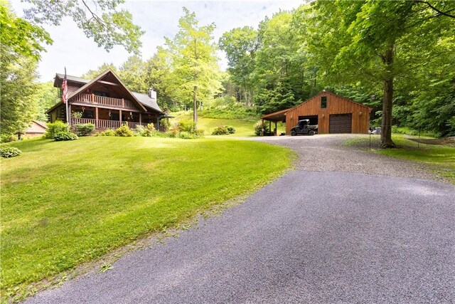 view of yard with a carport, a garage, and an outbuilding