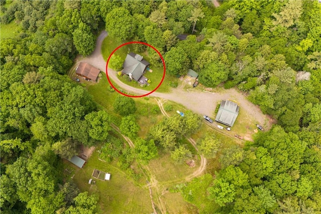 drone / aerial view with a wooded view