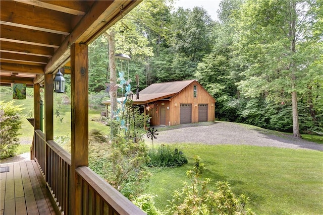 exterior space featuring an outbuilding, a yard, and a detached garage