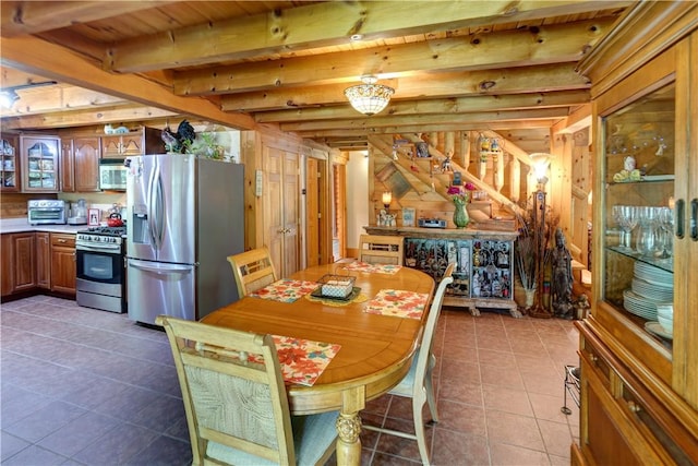 tiled dining space featuring a toaster, wooden walls, and beam ceiling