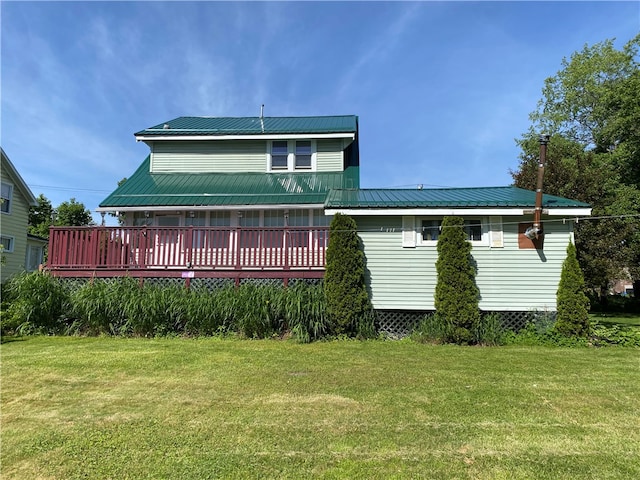 back of property featuring a lawn and a wooden deck