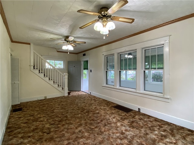 foyer featuring carpet, ceiling fan, and plenty of natural light