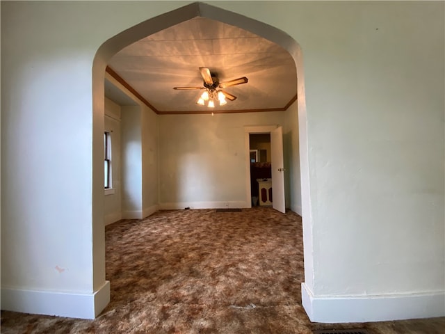 spare room featuring ornamental molding, ceiling fan, and carpet floors