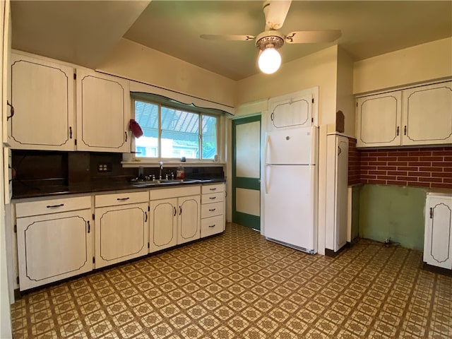 kitchen with tile floors, ceiling fan, sink, and white refrigerator