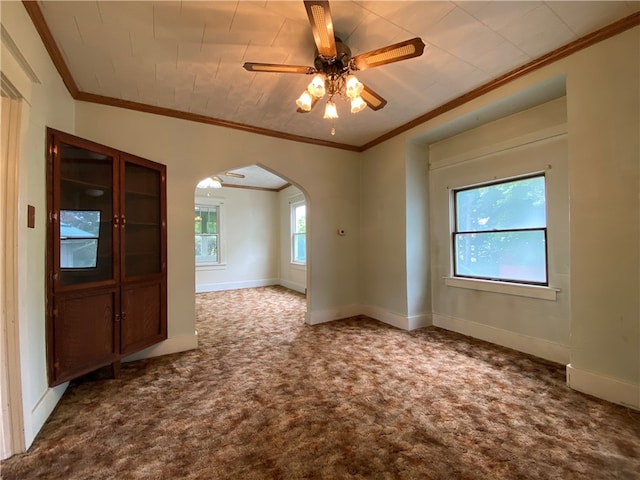 carpeted spare room with crown molding and ceiling fan