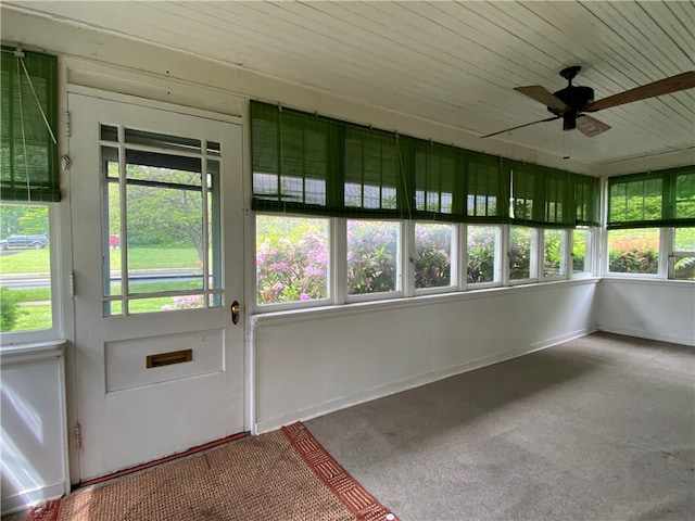 unfurnished sunroom featuring a wealth of natural light and ceiling fan