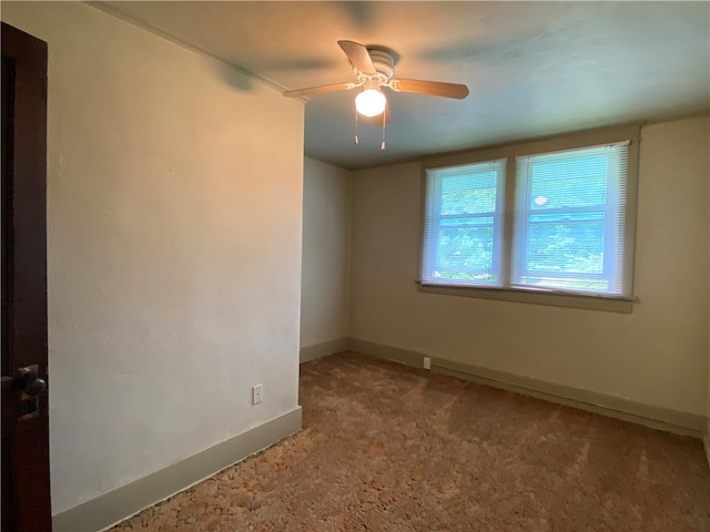 carpeted spare room with ceiling fan