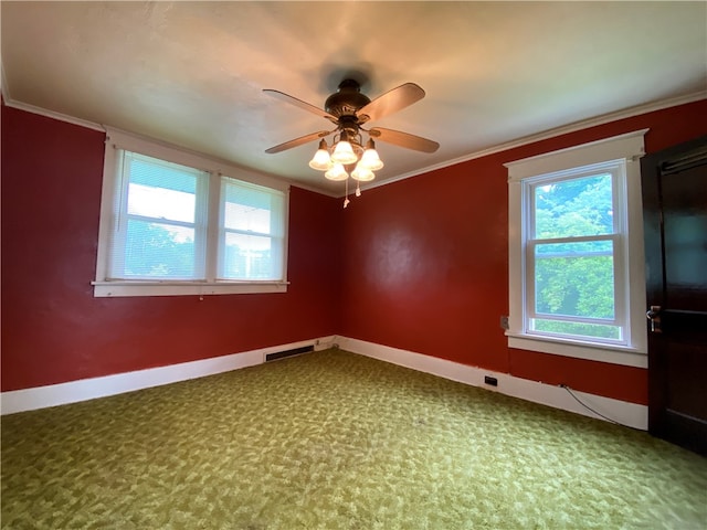 unfurnished room featuring ceiling fan, crown molding, and carpet flooring